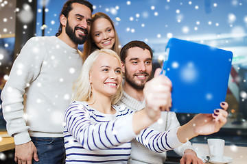 Image showing happy friends with tablet pc taking selfie at cafe