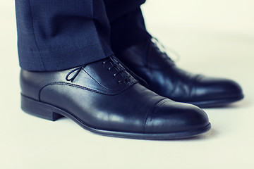 Image showing close up of man legs in elegant shoes with laces