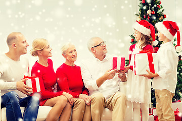 Image showing smiling family with gifts at home