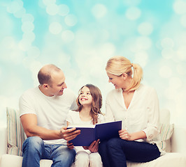 Image showing happy family with book at home