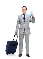 Image showing happy businessman in suit with travel bag