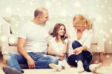 Image showing smiling parents and little girl at home