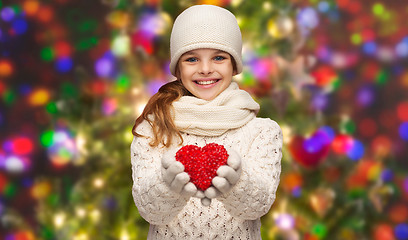 Image showing girl in winter clothes with small red heart