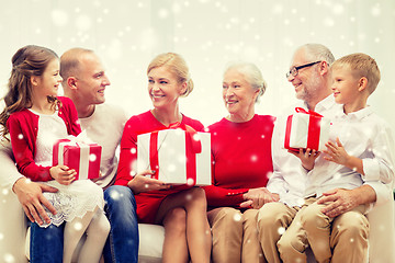 Image showing smiling family with gifts at home