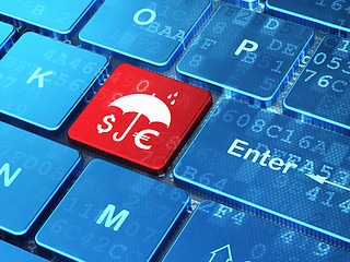 Image showing Safety concept: Money And Umbrella on computer keyboard background