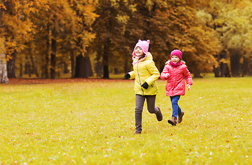 Image showing group of happy little girls running outdoors