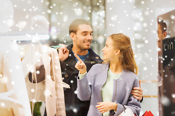 Image showing happy young couple with shopping bags in mall