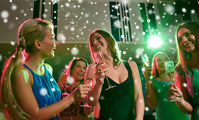 Image showing young women with glasses of champagne in club