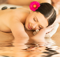 Image showing woman in spa with hot stones