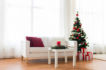 Image showing sofa, table and christmas tree with gifts at home