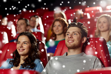 Image showing happy friends watching movie in theater