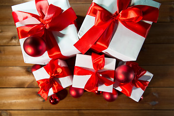 Image showing close up of gift boxes and red christmas balls