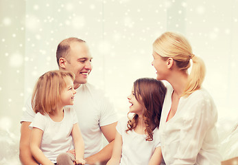 Image showing smiling parents and two little girls at home