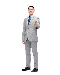 Image showing happy businessman in suit showing thumbs up