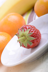 Image showing Fresh colorful fruits composition mandarin, strawberry, peach, bananas and orange