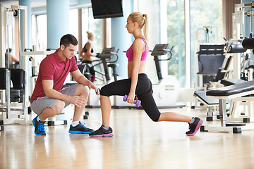 Image showing young sporty woman with trainer exercise weights lifting