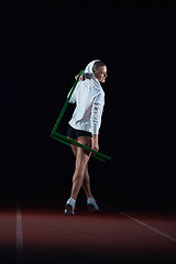 Image showing woman athlete jumping over a hurdles