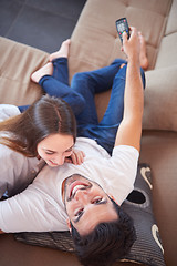 Image showing young couple watching tv at home