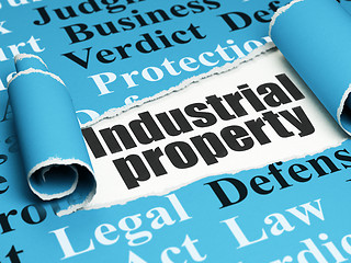 Image showing Law concept: black text Industrial Property under the piece of  torn paper