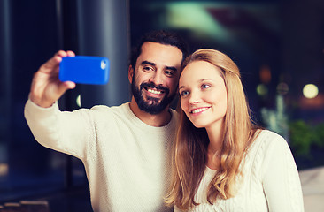 Image showing happy couple with tablet pc and coffee at cafe