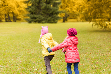 Image showing happy little girls running outdoors