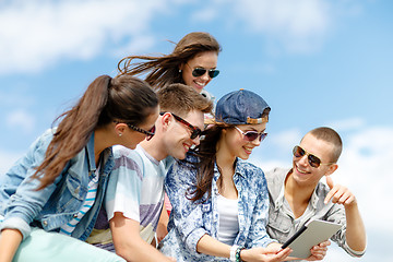 Image showing group of teenagers looking at tablet pc computer