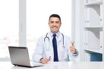 Image showing smiling doctor showing thumbs up in medical office