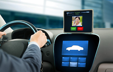 Image showing close up of man driving car and receiving call