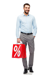 Image showing smiling man with red shopping bag