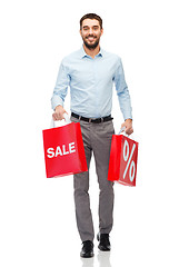 Image showing smiling man with red shopping bag