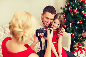 Image showing mother taking picture of father and daughter