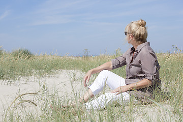 Image showing Vacationer sitting on the beach