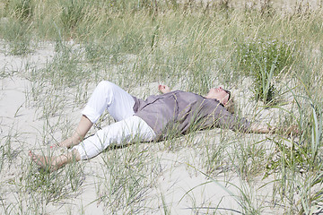 Image showing Vacationer lying in the dunes