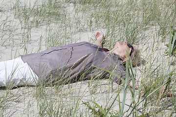 Image showing Woman lying in the dunes