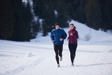 Image showing couple jogging outside on snow