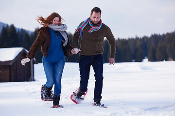 Image showing couple having fun and walking in snow shoes