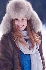 Image showing portrait of beautiful young redhair woman in snow scenery