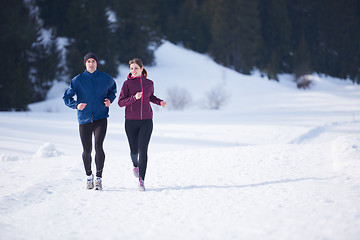 Image showing couple jogging outside on snow