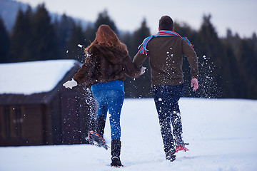 Image showing couple having fun and walking in snow shoes