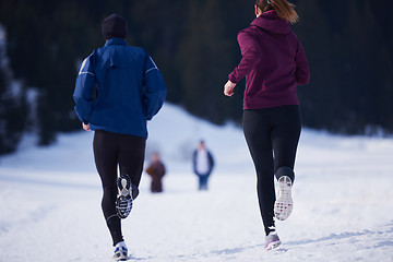 Image showing couple jogging outside on snow