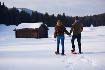 Image showing couple having fun and walking in snow shoes