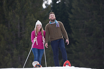 Image showing couple having fun and walking in snow shoes