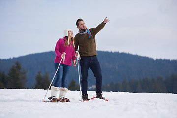 Image showing couple having fun and walking in snow shoes