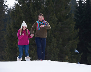 Image showing couple having fun and walking in snow shoes