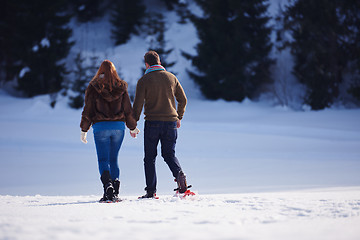 Image showing couple having fun and walking in snow shoes