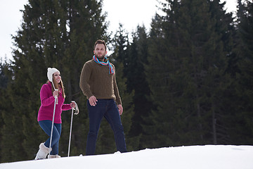 Image showing couple having fun and walking in snow shoes