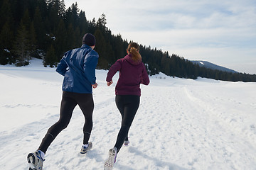 Image showing couple jogging outside on snow