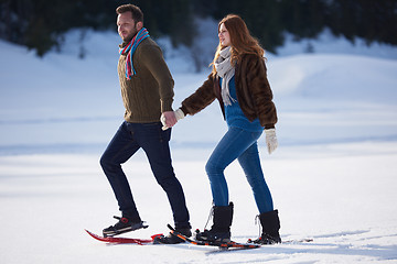 Image showing couple having fun and walking in snow shoes