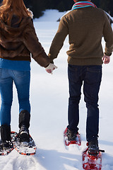 Image showing couple having fun and walking in snow shoes