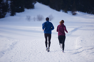 Image showing couple jogging outside on snow